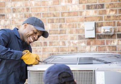 man repairing AC unit