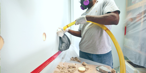 man installing wall insulation